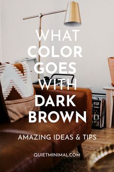 a living room with brown furniture and a lamp that says what color goes with dark brown