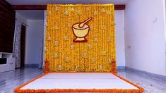 an orange and yellow backdrop with a mortar and pepper shaker on it in the middle of a room