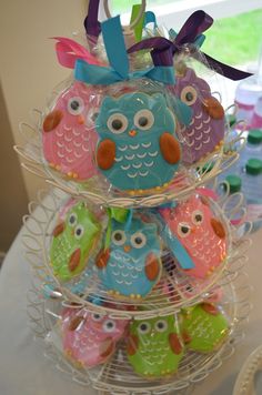 colorful cookies are stacked on top of each other in the shape of owl's