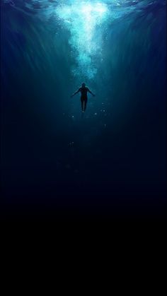 a person swimming in the ocean under water