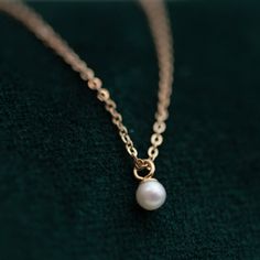 This Mini Pearl Pendant Necklace is the perfect complement for your evening wear or casual wardrobe. Crafted from 14k gold, this delicate necklace features a small cultured pearl, lending it a minimalist and elegant look. With this classic and versatile accessory, you're sure to make a statement. Pearl size: 2.75-3mm 1 Classic Akoya Pearl Necklace With Delicate Chain, Elegant 14k Gold Pearl Necklace, Classic Pearl Necklace With Delicate Chain, Classic Round Pearl Necklace With Delicate Chain, Classic Pearl Necklace With Delicate Chain For Formal Occasions, Refined Pearl Chain Necklace As Gift, Dainty Akoya Pearl Necklace With Delicate Chain, Refined Pearl Chain Necklace For Gift, Elegant Tiny Round Pendant Jewelry