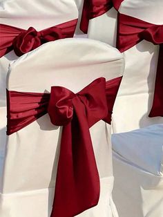 red and white chairs with bows on them