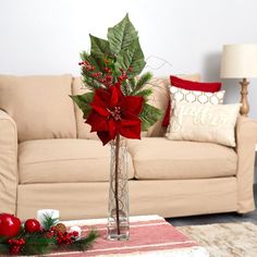 a living room filled with furniture and a christmas decoration on top of a coffee table