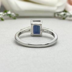 This beautiful ring is made from genuine 925 sterling silver with rhodium plating. Ring details- -The Main stone is an Emerald Cut 8mm by 6mm Lab Created Alexandrite Stone -Side stones are 4mm by 2mm Tapered Baguette simulated diamonds -Ring is casted in solid 925 sterling silver with rhodium plating (rose gold and yellow gold plated also available, please check the drop down menu for more options) -The Total face height of the ring measures 8mms and the band width measures 1.6mms -Each ring is Silver Emerald Ring With Princess Cut And Prong Setting, Silver Emerald Ring With Princess Cut, Silver Princess Cut Emerald Ring With Prong Setting, Silver Emerald Princess Cut Ring With Center Stone, Silver Princess Cut Gemstone Birthstone Ring, Silver Princess Cut Birthstone Ring With Gemstone, Promise Opal Ring In Sterling Silver, Silver Princess Cut Birthstone Ring, Sterling Silver Baguette Cut Wedding Rings