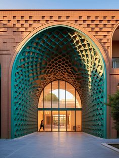 the entrance to a building with an arched doorway and large green archways on both sides