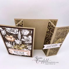 an open card with flowers on it and two tags attached to the front of each card