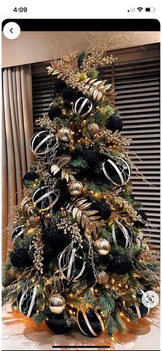 a christmas tree decorated with black and gold ornaments