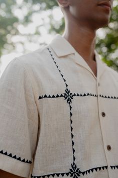 Sunlit squaresthe squares, a window to the afternoon sun, casting beautiful gentle patterns on this breathable cotton shirt Detail: Suf embroidery in beautiful squares throughout the shirt Color: Natural white kala cotton Fabric: Hand woven 1 by 1 kala cotton Fit: Leisure Fit Care Instructions: Hand wash and cool rinse. Drip dry in shade and steam/iron on the reverse side to preserve the fabric’s natural texture and sheen Model Information: Gopi is 5'10 and he is wearing a size Medium shirt Wear Shirt Fabric Texture, Suf Embroidery, Simple Cotton Shirt, Hand Painted Shirts, Embroidery For Men, Mens Embroidery