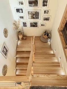 the stairs are made of wood and have pictures on the wall