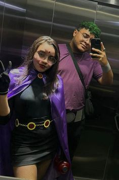 a man taking a selfie with a woman dressed as the joker in front of an elevator