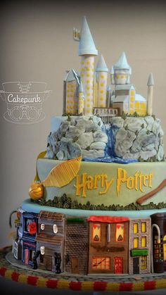 this is a cake made to look like a hogwarts castle with houses on top