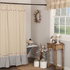 a bathroom with a sink, toilet and shower curtain