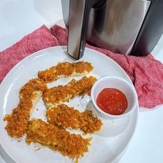 fried chicken strips on a plate with ketchup