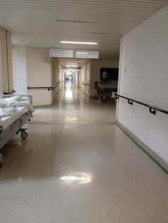 an empty hospital hallway with medical equipment on the floor