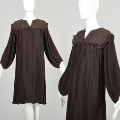 This is a lovely chocolate brown pleated dress by Edith Flagg. It features a babydoll style top with a solid panel across the shoulders and a small ruffle trim. The long wide balloon sleeves hit right at the wrist and have an elastic band. The body of the dress falls straight down to the knee in an oversized style.  Condition: Excellent.  Condition Details: No notable flaws.  Size Marked: 14 Approximate Size: Large **Please Check Measurements to be Sure! Textile: 100% Polyester Lining Type: Unli 1960s Dress, 1960's Dress, Babydoll Style, Oversized Dress, Oversized Style, Balloon Sleeves, Dress Clothes For Women, Fall Dresses, Pleated Dress