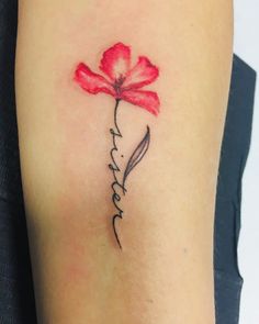 a red flower with the word love written in cursive writing on its arm