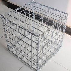 two metal baskets sitting on the floor next to each other