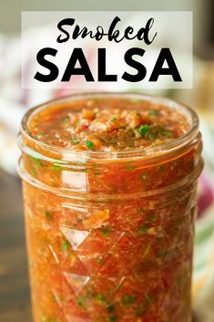 a jar filled with salsa sitting on top of a table