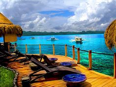 there are lounge chairs on the dock by the water