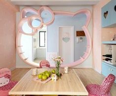 a room with hello kitty furniture in the center and a mirror on the wall above it