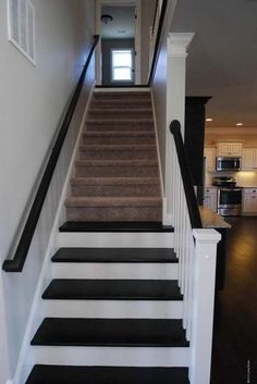 the stairs are painted black and white to match the house's interior color scheme