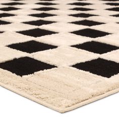 a black and white area rug with squares on the bottom, in various sizes and colors