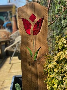 a piece of wood that has been made to look like a vase with flowers on it