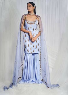 This periwinkle sharara set has a silk kurta with zardozi embroidery using royal motifs to form chandeliers along the necklines. The look is completed with pure silk sharara and pure organza scalloped dupatta. Silk Sharara, Blue Dupatta, Zardosi Embroidery, Reception Bride, Kurta Sharara Set, Party Reception, Organza Embroidery, Kurta Sharara, Zardozi Embroidery