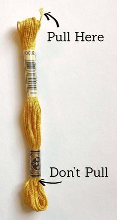 a skein of yellow yarn with the words pull here and don't pull