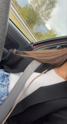 a woman sitting in the back seat of a car