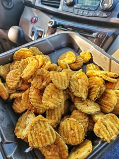 a tray filled with peeled bananas sitting on top of a car dashboard