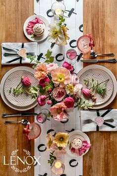 an overhead view of a table set with flowers and place settings for two people to eat