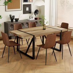 a dining room table with chairs and pictures on the wall