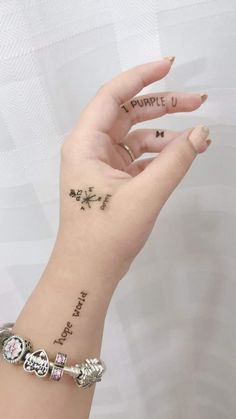 a woman's hand with tattoos on it and the words, i purple u