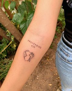 a woman's arm with a tattoo on it that reads provendos, and an image of a helmet