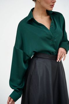 "Elegant green emerald satin shirt will accentuate your stylish look!  The straight collar, dropped shoulder line and asymmetrical hem of the shirt make it interesting, fastened with buttons.  The shirt can be worn in different variations, on the inside and out, tie the front edges of the shirt with a knot, the shirt goes well with any bottom from a classic style skirt to ripped jeans or leather shorts.  Suitable for casual everyday look, office and work, as well as for special occasions of graduation, birthday or holiday party.   DETAILS  - emerald green  - satin  - asymmetric hem  - straight collar  - dropped shoulder line  - buttoned     SIZES   This shirt is available in 2 sizes S-M and L-XL   Back length 29.52\"/ 75 cm  Dropped sleeve 17.7\"/ 45 cm  Shoulder 12.79\"/ 32.5 cm  S-M BUST Emerald Outfit Casual, Emerald Green Blouse Outfit Work, Satin Collared Shirt Outfit, Emerald Green Style Outfit, Green Satin Button Up Outfit, Emerald Green Work Outfit, Green Chemise Outfit, Emerald Shirt Outfit, Emerald Green Clothes Casual