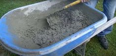 a man is shoveling dirt into a wheelbarrow