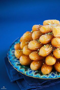 a plate full of almonds on a blue cloth