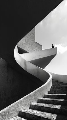 black and white photograph of stairs leading up to a building with sky in the background