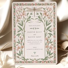 a wedding card with flowers and dragonflies on it