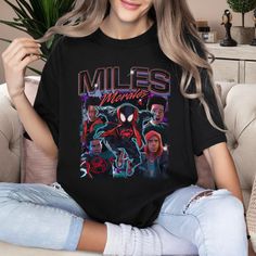 Miles Morales Shirt, Miles Morales Homage T-Shirt, Funny Spider Man Hero Shirt, Black Spider-Man Across Tee, Superhero Birthday Gift LS5298 Welcome to my store! I will help you to have a good shopping experience as much as I can. If you have any request please feel free to message me. I will reply as soon as possible. I have listed some information to help you below: HOW TO ORDER? : Choose the color and size you want. If available, enter the customization information in the text box. Click the Add to Cart button. You can go back and add other items to your cart to buy more. - Decoration type: Digital Print - High material + 100% heavy cotton include styles: Classic T-shirt, Youth T-shirt, Women T-shirt, Unisex Tank Top + 50/50 cotton/poly include styles: Sweatshirt, Hoodie + 100% combed ri Crew Neck Top With Front Print For Fan Conventions, Black Graphic Tee For Fan Conventions, Black Top With Front Print For Fan Conventions, Black Tops With Front Print For Fan Conventions, Character Print Crew Neck Top For Fan Conventions, Crew Neck Tops With Character Print For Fan Conventions, Black Short Sleeve Top For Fan Conventions, Black Pop Culture Top With Sublimation Print, Black Pop Culture Tops With Sublimation Print