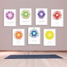 a yoga mat sits in front of a wall with seven chakras on it