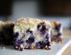 two pieces of blueberry cheesecake on a white plate