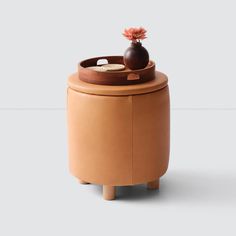 a small stool with a potted plant on top