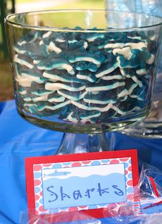 a bowl filled with blue and white sprinkles on top of a table