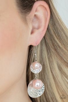 a close up of a person wearing some kind of earring with pearls on it