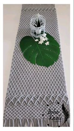 a table runner with a green leaf on it