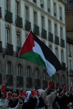 many people are holding up their hands in the air with an italian flag on it