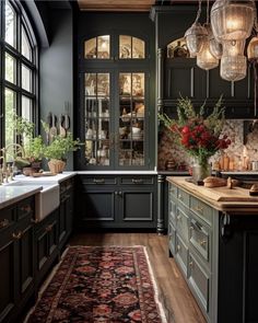 an elegant kitchen with dark green cabinets and wood flooring, chandelier hanging from the ceiling