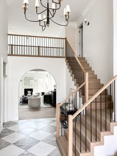 an entry way with stairs and chandelier